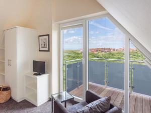 a living room with a view of the ocean at Dünenhuus Ost Modern retreat in Juist