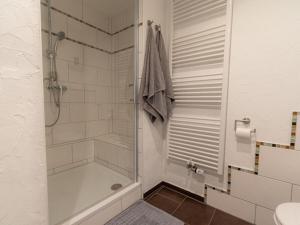 a bathroom with a shower and a tub and a sink at "Schmiedegässchen" Comfortable holiday residence in Kamp-Bornhofen +12 photos