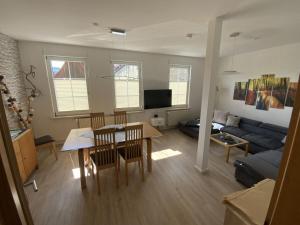a living room with a table and a couch at Holiday apartment on the Anger in Wernigerode