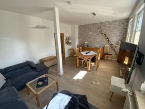 a living room with a blue couch and a table at Holiday apartment on the Anger in Wernigerode