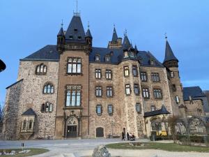 a large brick building with a tower on top at Holiday apartment on the Anger in Wernigerode