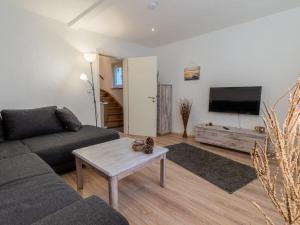 a living room with a couch and a coffee table at "Schmiedegässchen" Comfortable holiday residence in Kamp-Bornhofen
