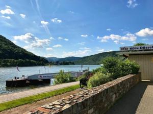 a river with a boat docked at a marina at "Schmiedegässchen" Comfortable holiday residence in Kamp-Bornhofen