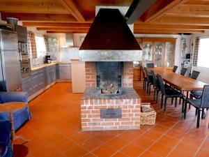 OsterheverにあるPoppenbüll thatched houseのキッチン(レンガ造りの暖炉、テーブル、椅子付)