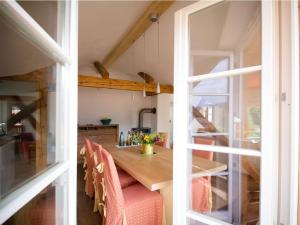 a dining room with a table and a large window at Plaatsje in het Mesnerhuis in Lenggries +20 photos