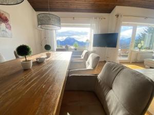 a living room with a couch and a wooden table at Villa Alpenblick Comfortable holiday residence in Füssen