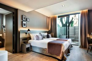 a bedroom with a large bed and a large window at Upper Diagonal in Barcelona
