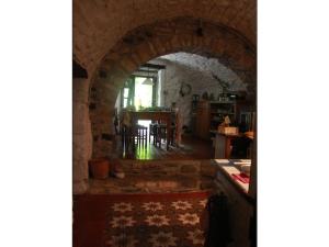 an archway in a room with a kitchen and a table at Holiday home Mirabel Sous les roches in Mirabel +12 photos