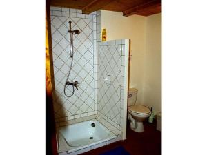 a bathroom with a shower with a tub and a toilet at Holiday home Mirabel Sous les roches in Mirabel