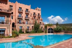 a large swimming pool in front of a building at Chems Du Lac Bin El Ouidane in Bine el Ouidane