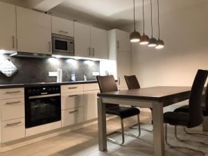 een keuken met een tafel en stoelen in een kamer bij Beach apartment Prora Captain in Prora