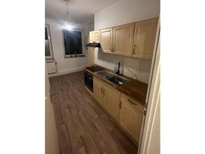 a kitchen with a sink and a stove top oven at Gießler Comfortable holiday residence in Bremerhaven +2 photos