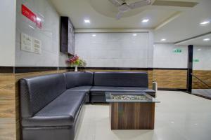 a black leather couch in a waiting room at Hotel O Sion Residency in Mumbai
