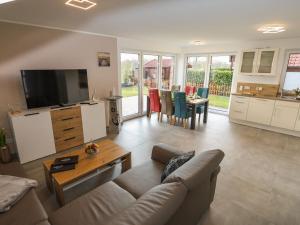 a living room with a couch and a table at Marinapark 147 Modern retreat in Walchum