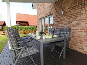 a gray table and chairs on a patio at Marinapark 147 Modern retreat in Walchum