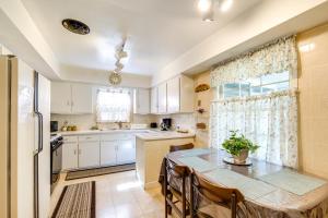 a kitchen with a table and a dining room at Cleveland Heights Home with Sunroom Park Across St! in Cleveland Heights