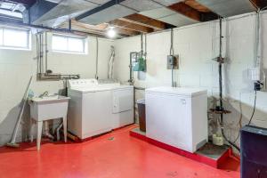 a laundry room with washing machines and a sink at Cleveland Heights Home with Sunroom Park Across St! in Cleveland Heights +25 photos