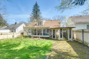 a house with a fence and a yard at Cleveland Heights Home with Sunroom Park Across St! in Cleveland Heights