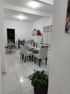 a kitchen and dining room with a table and chairs at Porto Belo Perequê in Porto Belo +7 photos