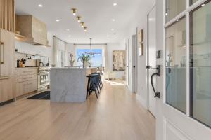 a kitchen with a island in the middle of a room at Pocasset Family retreat ocean view in Bourne