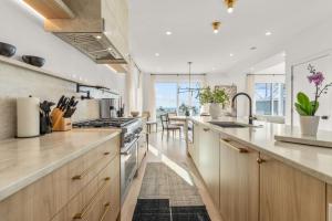 a kitchen with wooden cabinets and a counter top at Pocasset Family retreat ocean view in Bourne