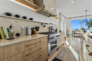 a kitchen with a stove top oven next to a table at Pocasset Family retreat ocean view in Bourne