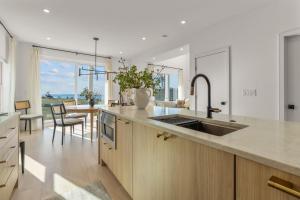a kitchen with a sink and a counter with a table at Pocasset Family retreat ocean view in Bourne +58 photos