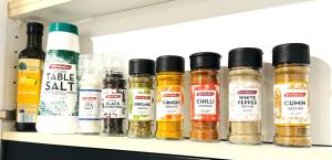 a shelf filled with spices and condiments at Beautiful 5bedroom farmhouse 15 min from Canberra CBD in Sutton