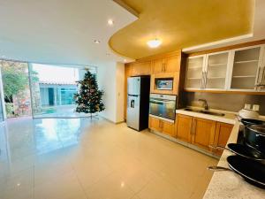 a kitchen with a christmas tree in the middle at 20# Habitación doble cama in Miravalle +8 photos