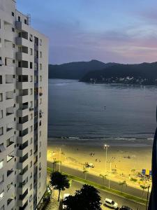 a view of a beach and a building at Kitnet 1109 in São Vicente +3 photos