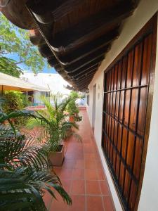 a hallway of a house with plants on it at Hotel Casa Alemán Mompos Bolivar in Mompós