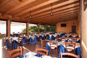 a banquet hall with tables and chairs with blue tables at Agriturismo La Molara in Sessa Aurunca