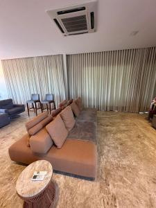a living room with a couch and a table at Casa Temporada Praia do Forte, Complexo Iberostate, 5 Suítes in Praia do Forte