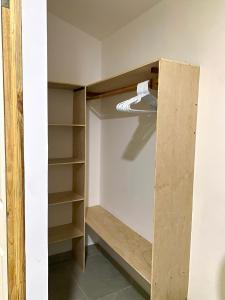 a closet with a wooden door and shelves at Hostal El Amate #3 in Suchitoto