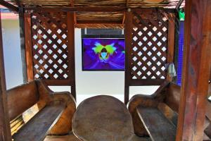 two wooden chairs with a tv in a room at Hotel Riviera D Amazonia Belem Ananindeua in Belém