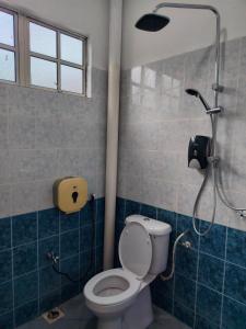 a bathroom with a shower with a toilet in it at Pearl Villa 5 Bedroom Unit 1 in Port Dickson