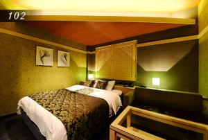 Ένα ή περισσότερα κρεβάτια σε δωμάτιο στο Hotel Ayung 大人専用