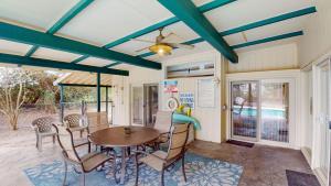 a dining room with a table and chairs at GREAT DUNES COTTAGE home in Jekyll Island +28 photos