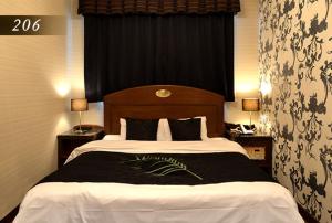 Ένα ή περισσότερα κρεβάτια σε δωμάτιο στο Hotel Ayung 大人専用