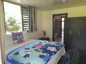 Ένα ή περισσότερα κρεβάτια σε δωμάτιο στο Tubuai Fare Hivanui