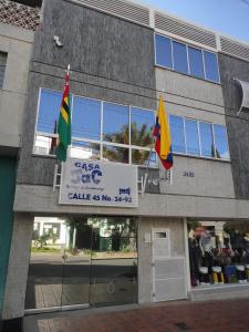 a store with two flags in front of a building at Casa Jac in Bucaramanga