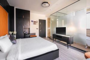 Voodi või voodid majutusasutuse Greenview City Hotel toas