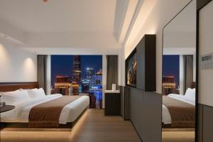 Mcsrh Hotel-Changsha IFS and WUYI Plaza客房内的一张或多张床位