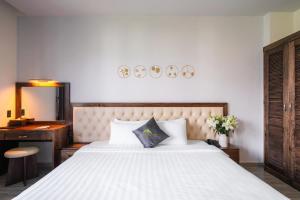 Voodi või voodid majutusasutuse Greenview City Hotel toas