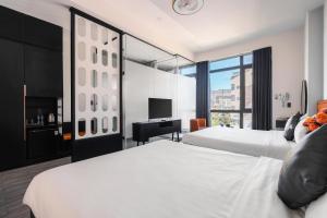 Voodi või voodid majutusasutuse Greenview City Hotel toas