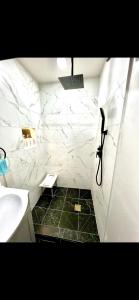 a bathroom with a sink and a white marble wall at Furnished apartmt near down town with king bed in Dallas