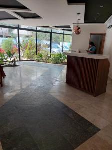 a lobby with a counter in a building with plants at Infinity Pool rooftop wifi Tulum in Tulum +37 photos