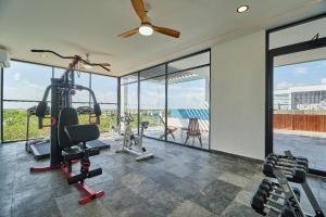 a fitness room with a gym with a view at Infinity Pool rooftop wifi Tulum in Tulum