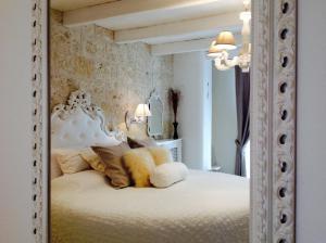 a bedroom with a white bed with a large mirror at Playa del Mar - Adults Only in Monopoli +37 photos
