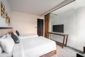 Voodi või voodid majutusasutuse Greenview City Hotel toas